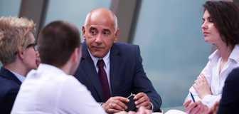 Four colleagues around a conference table